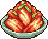 A plate of kimchi in the middle of the table